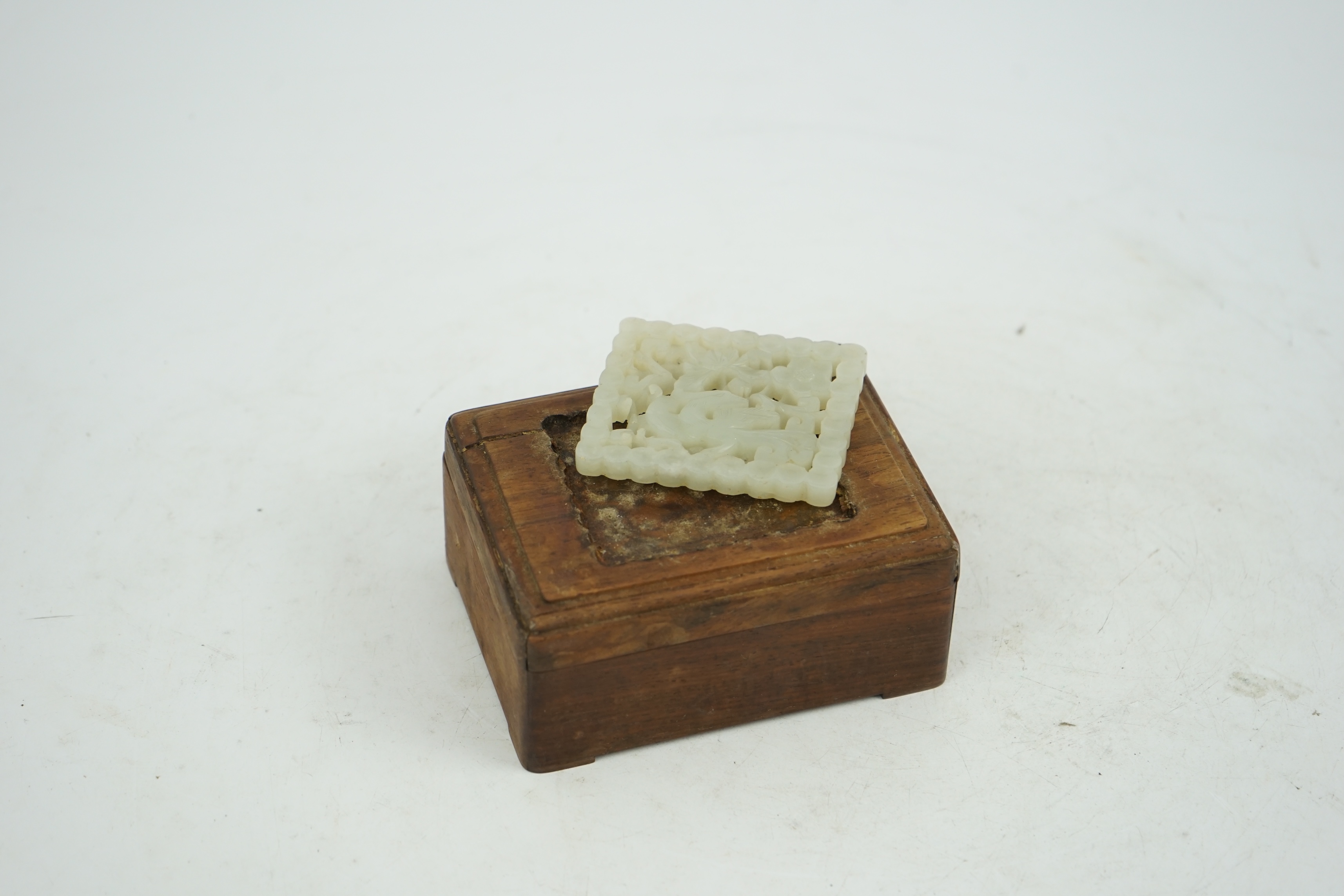 A Chinese pale celadon jade plaque, 17th/18th century, now inset into a hongmu box